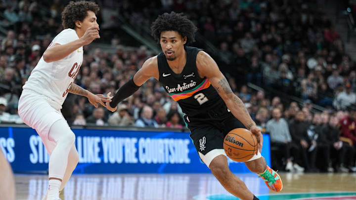 Dec 29, 2025; San Antonio, Texas, USA;  San Antonio Spurs guard Dylan Harper (2) dribbles against Cleveland Cavaliers guard Craig Porter Jr. (9) in the second half at Frost Bank Center. 