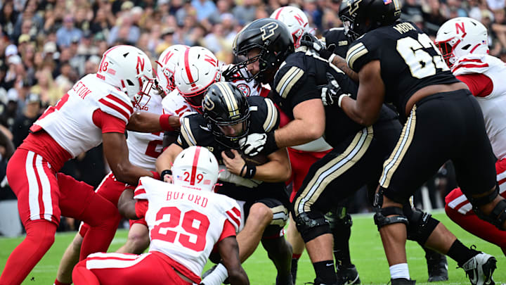 Purdue Boilermakers quarterback Hudson Card (1) is sacked by several Nebraska Cornhuskers 