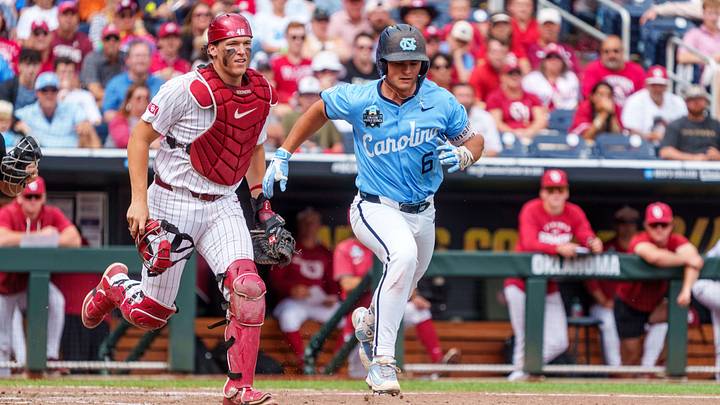 Jun 21, 2026; Omaha, NE, USA; North Carolina Tar Heels catcher Macon Winslow (6) is chased by Oklahoma Sooners catcher Deiten Lachance (48) during the eighth inning at Charles Schwab Field. Mandatory Credit: Dylan Widger-Imagn Images