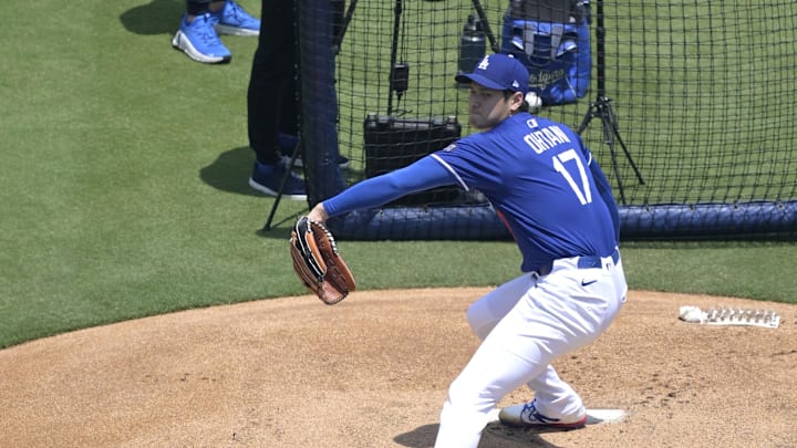 May 31, 2025; Los Angeles, California, USA;  Los Angeles Dodgers pitching coach Mark Prior (99) and interpreter Will Ireton watch as Shohei Ohtani (17) throws live batting practice prior to the game against the New York Yankees at Dodger Stadium. Mandatory Credit: Jayne Kamin-Oncea-Imagn Images