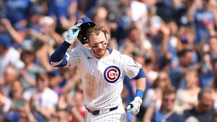 Ian Happ celebrates a home run in front of Chicago Cubs fans at Wrigley Field.