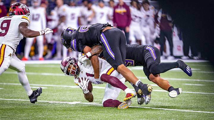 UW defenders Isaiah Ward and Jacob Manu combine to sack Minnesota quarterback Drake Lindsey.
