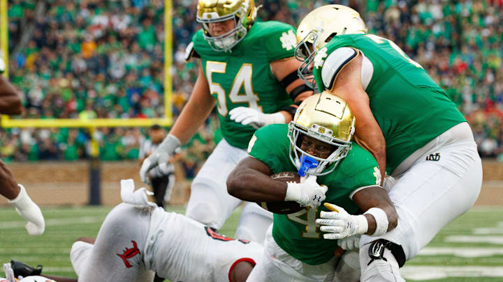 Notre Dame running back Jeremiyah Love (4) falls into the end zone for a touchdown during a NCAA college football game between Notre Dame and Louisville at Notre Dame Stadium on Saturday, Sept. 28, 2024, in South Bend. Notre Dame running back Jeremiyah Love (4) falls into the end zone for a touchdown during a NCAA college football game between Notre Dame and Louisville at Notre Dame Stadium on Saturday, Sept. 28, 2024, in South Bend.