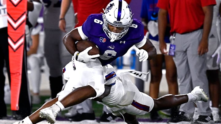 ACU running back Sam Hicks eludes West Georgia safety Jalen Frazier.