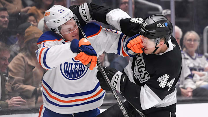Edmonton Oilers center Trent Frederic (21) and Los Angeles Kings defenseman Mikey Anderson (44) mix it up