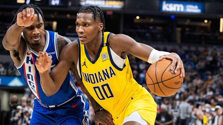 Feb 2, 2024; Indianapolis, Indiana, USA; Indiana Pacers guard Bennedict Mathurin (00) dribbles the ball while  Sacramento Kings guard Davion Mitchell (15) defends in the first half at Gainbridge Fieldhouse. Mandatory Credit: Trevor Ruszkowski-Imagn Images