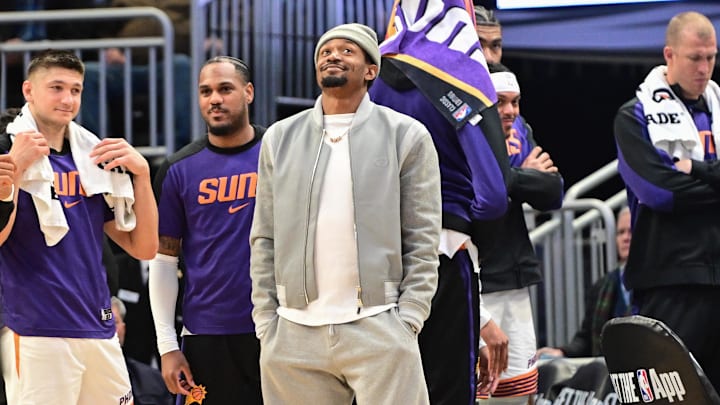 Apr 1, 2025; Milwaukee, Wisconsin, USA;  Phoenix Suns guard Bradley Beal (center) looks on in the fourth quarter while sidelined with an injury against the Milwaukee Bucks at Fiserv Forum. Mandatory Credit: Benny Sieu-Imagn Images