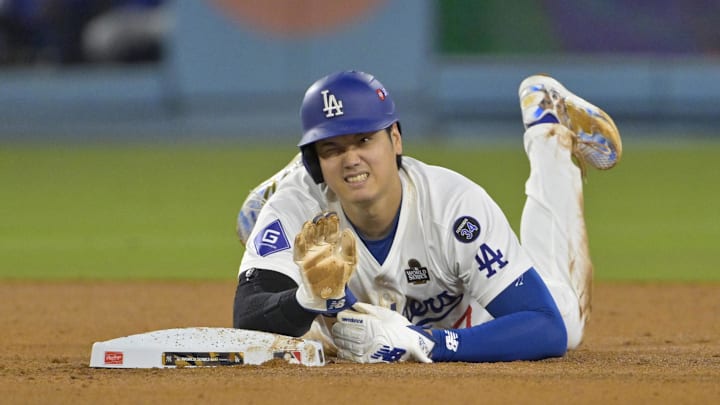 Oct 26, 2024; Los Angeles, California, USA; Los Angeles Dodgers designated hitter Shohei Ohtani (17) reacts at second base after an apparent injury in the seventh inning against the New York Yankees during Game 2 of the 2024 MLB World Series at Dodger Stadium.