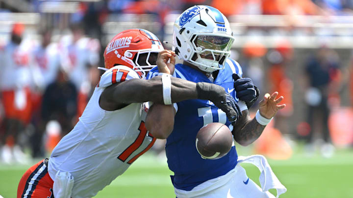 Sep 6, 2025; Durham, North Carolina, USA; Illinois Fighting Illini linebacker Gabe Jacas (17) swats the ball from Duke Blue Devils quarterback Darian Mensah (10) during the second quarter at Wallace Wade Stadium. Mandatory Credit: Zachary Taft-Imagn Images Sep 6, 2025; Durham, North Carolina, USA; Illinois Fighting Illini linebacker Gabe Jacas (17) swats the ball from Duke Blue Devils quarterback Darian Mensah (10) during the second quarter at Wallace Wade Stadium. Mandatory Credit: Zachary Taft-Imagn Images
