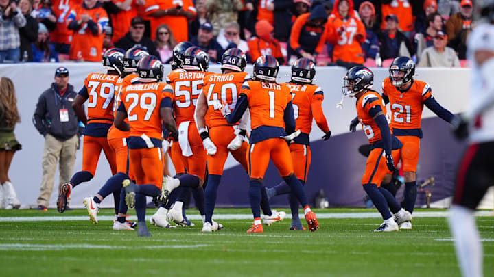 Nov 17, 2024; Denver, Colorado, USA; Members of the Denver Broncos defensive squad celebrate a turnover in the second half against the Atlanta Falcons at Empower Field at Mile High. Mandatory Credit: Ron Chenoy-Imagn Images