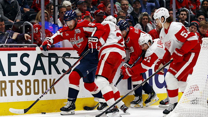 Mar 18, 2025; Washington, District of Columbia, USA; Washington Capitals right wing Taylor Raddysh (16) goes for the puck against Detroit Red Wings defenseman Albert Johansson (20) during the first period at Capital One Arena. Mandatory Credit: Peter Casey-Imagn Images