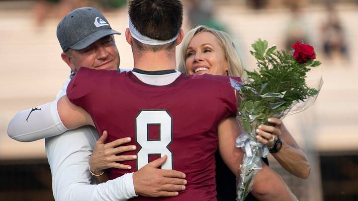 Zak Herbstreit (8) hugs his parents, Kirk Herbstreit and Alison Butler, during Senior Night ceremonies before their game against Briarcrest at Montgomery Bell Academy Zak Herbstreit (8) hugs his parents, Kirk Herbstreit and Alison Butler, during Senior Night ceremonies before their game against Briarcrest at Montgomery Bell Academy