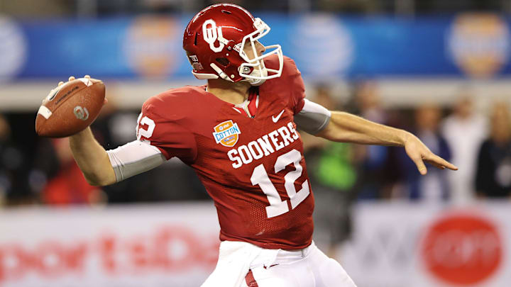 Jan 04, 2013; Arlington, TX, USA; Oklahoma Sooners quarterback Landry Jones (12) throws during the game against the Texas A&M Aggies in the 2013 Cotton Bowl at Cowboys Stadium. Mandatory Credit: Kevin Jairaj-Imagn Images