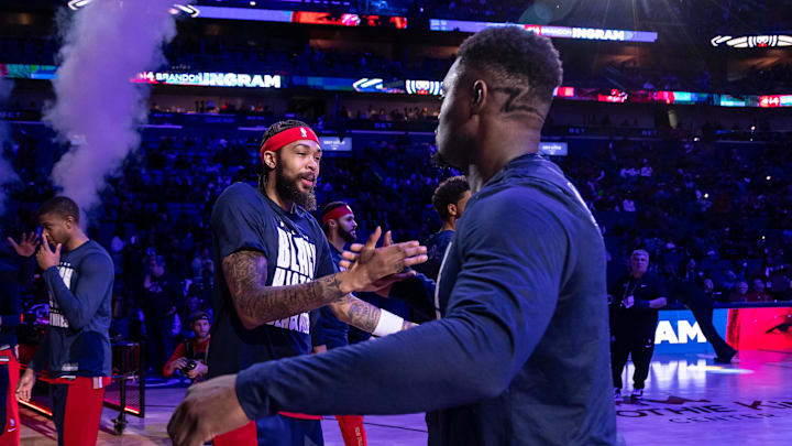 Feb 14, 2024; New Orleans, Louisiana, USA;  New Orleans Pelicans forward Brandon Ingram (14) hugs forward Zion Williamson (1) as he is announced to the fans to start the game against the Washington Wizards during the first half at Smoothie King Center. Mandatory Credit: Stephen Lew-Imagn Images