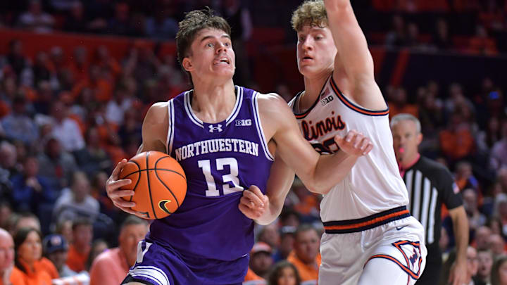 Jan 26, 2025; Champaign, Illinois, USA;  Northwestern Wildcats guard Brooks Barnhizer (13) drives the ball against Illinois Fighting Illini guard Kasparas Jakucionis (32) during the second half at State Farm Center. Mandatory Credit: Ron Johnson-Imagn Images
