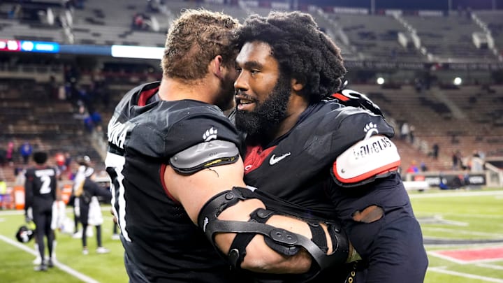Cincinnati Bearcats offensive lineman Luke Kandra and Cincinnati Bearcats defensive end Jowon Briggs