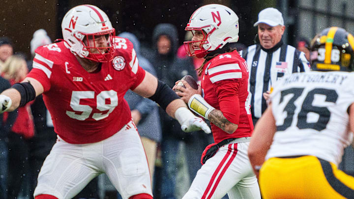 Nebraska quarterback TJ Lateef, protected by Henry Lutovsky, throws pass in third quarter vs. Iowa. 