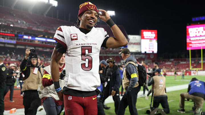 Jan 12, 2025; Tampa, Florida, USA; Washington Commanders quarterback Jayden Daniels (5) celebrates after winning a NFC wild card playoff against the Tampa Bay Buccaneers at Raymond James Stadium. Mandatory Credit: Nathan Ray Seebeck-Imagn Images