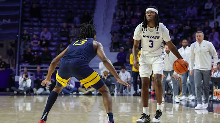 Mar 3, 2026; Manhattan, Kansas, USA; Kansas State Wildcats guard C.J. Jones (3) dribbles against West Virginia Mountaineers guard Chance Moore (13) during the second half at Bramlage Coliseum. Mar 3, 2026; Manhattan, Kansas, USA; Kansas State Wildcats guard C.J. Jones (3) dribbles against West Virginia Mountaineers guard Chance Moore (13) during the second half at Bramlage Coliseum.