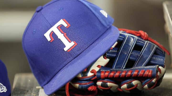 A hat and glove of a Texas Rangers player during a game against the Toronto Blue Jays at Rogers Centre. A hat and glove of a Texas Rangers player during a game against the Toronto Blue Jays at Rogers Centre.