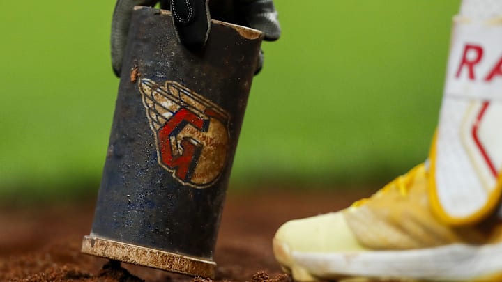 Aug 15, 2023; Cincinnati, Ohio, USA; Cleveland Guardians third baseman Jose Ramirez picks up batting equipment while preparing on deck during the seventh inning in the game against the Cincinnati Reds at Great American Ball Park. Mandatory Credit: Katie Stratman-Imagn Images
