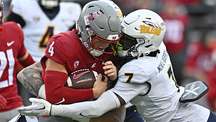 Washington State Cougars quarterback Zevi Eckhaus is tackled by Toledo Rockets safety Emmanuel McNeil-Warren.