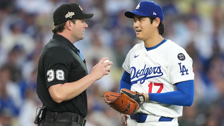 Oct 17, 2025; Los Angeles, California, USA; Los Angeles Dodgers two-way player Shohei Ohtani (17) talks with home plate umpire Adam Beck (38) in the second inning against the Milwaukee Brewers during game four of the NLCS round for the 2025 MLB playoffs at Dodger Stadium. Mandatory Credit: Kirby Lee-Imagn Images Oct 17, 2025; Los Angeles, California, USA; Los Angeles Dodgers two-way player Shohei Ohtani (17) talks with home plate umpire Adam Beck (38) in the second inning against the Milwaukee Brewers during game four of the NLCS round for the 2025 MLB playoffs at Dodger Stadium. Mandatory Credit: Kirby Lee-Imagn Images