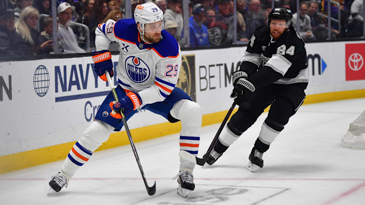 Apr 29, 2025; Los Angeles, California, USA; Edmonton Oilers center Leon Draisaitl (29) moves the puck against Los Angeles Kings defenseman Vladislav Gavrikov (84) during the first period in game five of the first round of the 2025 Stanley Cup Playoffs at Crypto.com Arena. Mandatory Credit: Gary A. Vasquez-Imagn Images