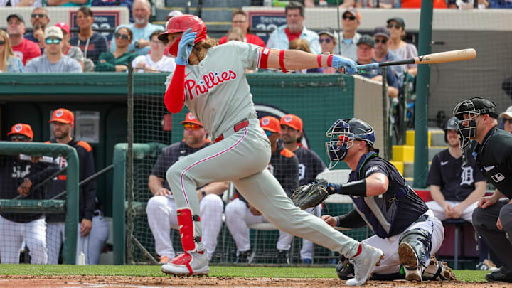 Feb 22, 2025; Lakeland, Florida, USA; Philadelphia Phillies third base Alec Bohm (28) hits during the third inning against the Detroit Tigers at Publix Field at Joker Marchant Stadium.