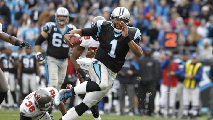 Dec, 24, 2011; Charlotte, NC, USA; Carolina Panthers quarterback Cam Newton (1) scores a touchdown in the third quarter as Tampa Bay Buccaneers free safety Tanard Jackson (36) defends. The Panthers defeated the Buccaneers 48-16 at Bank of America Stadium. Mandatory Credit: Bob Donnan-Imagn Images