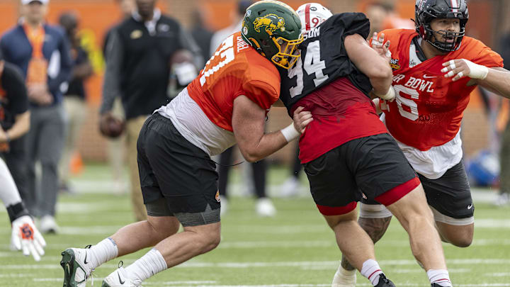 Jan 30, 2025; Mobile, AL, USA; National team offensive lineman Grey Zabel of North Dakota State (77) and National team offensive lineman Caleb Rogers of Texas Tech (76) battle with National team defensive lineman Ty Robinson of Nebraska (94) during Senior Bowl practice for the National team at Hancock Whitney Stadium. Mandatory Credit: Vasha Hunt-Imagn Images