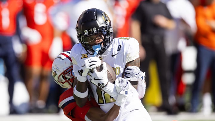 Oct 19, 2024; Tucson, Arizona, USA; Colorado Buffalos wide receiver Travis Hunter (12) is tackled by Arizona Wildcats cornerback Tacario Davis (1) at Arizona Stadium. Mandatory Credit: Mark J. Rebilas-Imagn Images