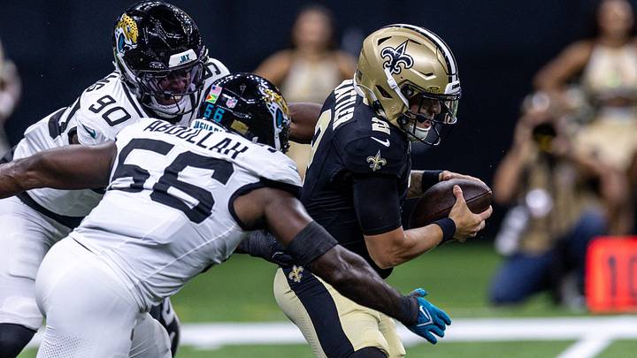 Aug 15, 2026; New Orleans, Louisiana, USA;  New Orleans Saints quarterback Spencer Rattler (2) scrambles from the pocket and fumbles the ball against Jacksonville Jaguars linebacker Yasir Abdullah (56) during the first half at Caesars Superdome. 