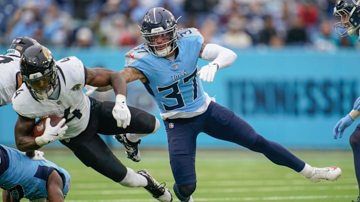 Jacksonville Jaguars running back Tank Bigsby (4) is stopped by Tennessee Titans safety Amani Hooker (37) during the third quarter at Nissan Stadium in Nashville, Tenn., Sunday, Dec. 8, 2024.