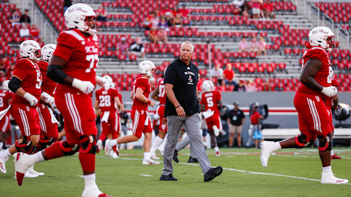 Aug 28, 2025; Raleigh, North Carolina, USA; North Carolina State Wolfpack head coach Dave Doeren walks among his players during the warmups prior to the game against East Carolina Pirates at Carter-Finley Stadium. Mandatory Credit: Jaylynn Nash-Imagn Images Aug 28, 2025; Raleigh, North Carolina, USA; North Carolina State Wolfpack head coach Dave Doeren walks among his players during the warmups prior to the game against East Carolina Pirates at Carter-Finley Stadium. Mandatory Credit: Jaylynn Nash-Imagn Images