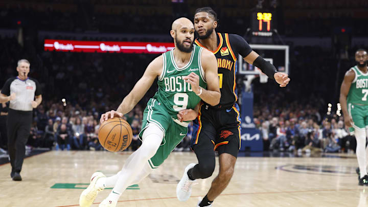 Jan 5, 2025; Oklahoma City, Oklahoma, USA; Boston Celtics guard Derrick White (9) drives around Oklahoma City Thunder guard Isaiah Joe (11) during the second quarter at Paycom Center. Mandatory Credit: Alonzo Adams-Imagn Images