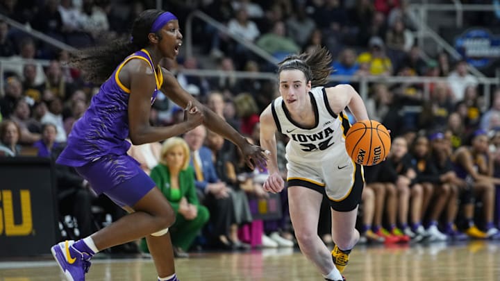 Apr 1, 2024; Albany, NY, USA; Iowa Hawkeyes guard Caitlin Clark (22) controls the ball against LSU Lady Tigers guard Flau'jae Johnson (4) in the fourth quarter in the finals of the Albany Regional in the 2024 NCAA Tournament at MVP Arena. Mandatory Credit: Gregory Fisher-Imagn Images