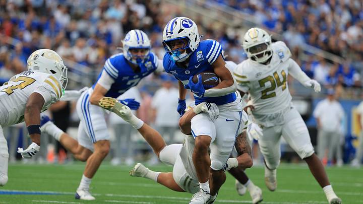 Dec 27, 2025; Orlando, FL, USA; BYU Cougars running back Jovesa Damuni (28) runs with the ball against the Georgia Tech Yellow Jackets  during the first half at Camping World Stadium. Mandatory Credit: Kim Klement Neitzel-Imagn Images
