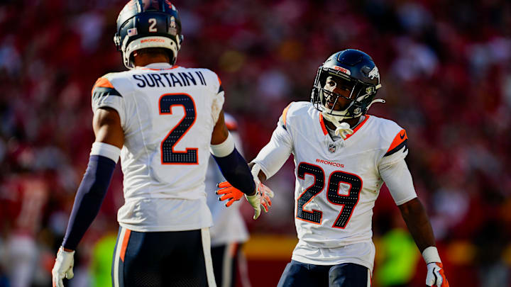 Denver Broncos cornerback Ja'Quan McMillian (29) celebrates with cornerback Pat Surtain II (2) after a play during the second half against the Kansas City Chiefs at GEHA Field at Arrowhead Stadium.