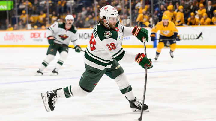 Jan 18, 2025; Nashville, Tennessee, USA;  Minnesota Wild right wing Ryan Hartman (38) takes a shot on goal against the Nashville Predators during the second period at Bridgestone Arena. Mandatory Credit: Steve Roberts-Imagn Images