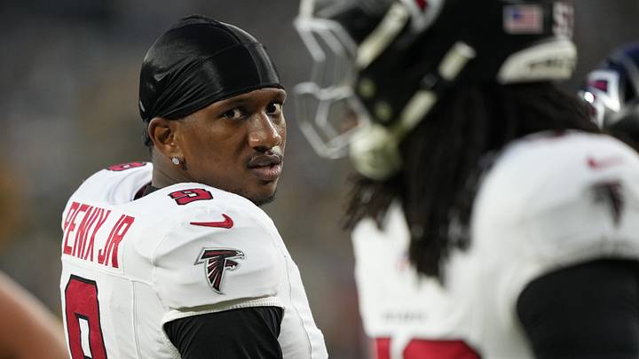 Michael Penix Jr. (9) looks on during warm-ups prior to Thursday night's Atlanta-Green Bay football game. Michael Penix Jr. (9) looks on during warm-ups prior to Thursday night's Atlanta-Green Bay football game.