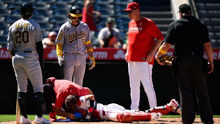 Sep 7, 2025; Anaheim, California, USA; Los Angeles Angels catcher Logan O'Hoppe (14) is tended to after being hit by a ball during the seventh inning against the Athletics at Angel Stadium. Mandatory Credit: William Liang-Imagn Images