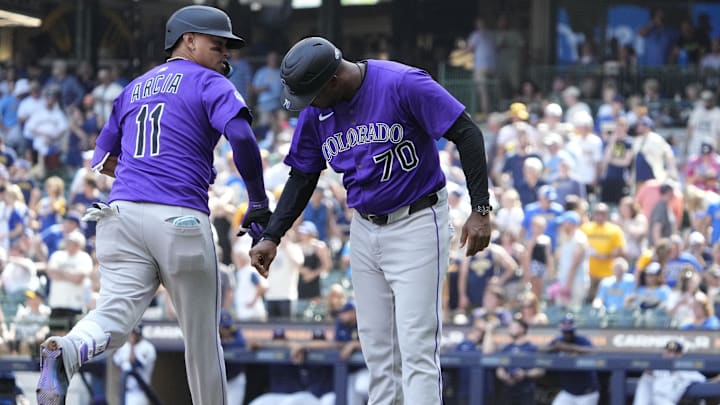 Jun 29, 2025; Milwaukee, Wisconsin, USA; Colorado Rockies third base coach Andy González (70) congratulates shortstop Orlando Arcia (11) after hitting a home run against the Milwaukee Brewers in the ninth inning at American Family Field. 