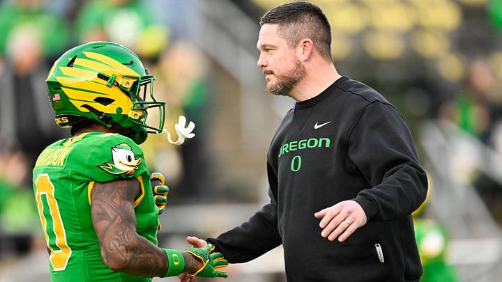 Dec 20, 2025; Eugene, OR, USA; Oregon Ducks head coach Dan Lanning greets Oregon Ducks running back Jordon Davison (0) before the game against the James Madison Dukes at Autzen Stadium. Mandatory Credit: Troy Wayrynen-Imagn Images