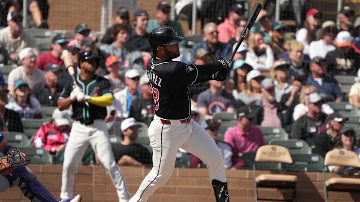 Mar 3, 2025; Salt River Pima-Maricopa, Arizona, USA; Arizona Diamondbacks third base Eugenio Suarez (28) hits an RBI single against the Chicago Cubs in the first inning at Salt River Fields at Talking Stick. Mandatory Credit: Rick Scuteri-Imagn Images