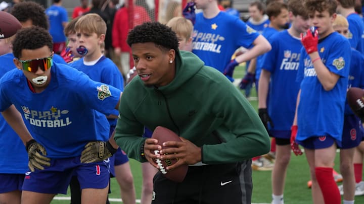 exas Longhorns receiver Matthew Golden at the NFL Draft prospect clinic with Special Olympics at Draft Experience Field at Titletown. 