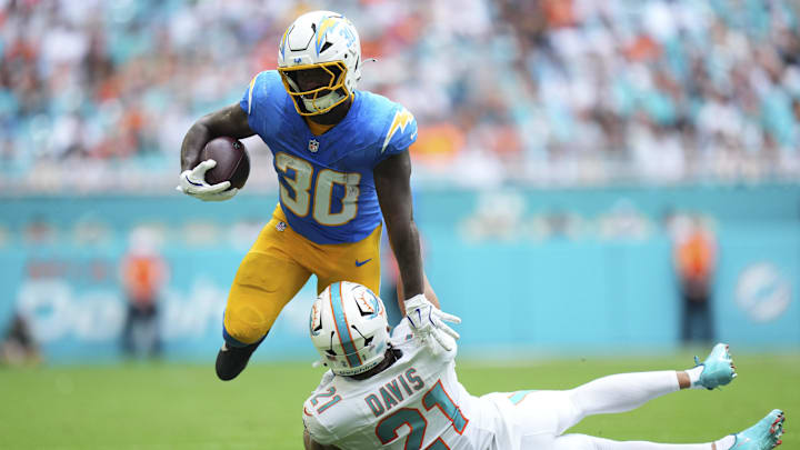 Oct 12, 2025; Miami Gardens, Florida, USA; Miami Dolphins safety Ashtyn Davis (21) tackles Los Angeles Chargers running back Kimani Vidal (30) during the second quarter at Hard Rock Stadium. Mandatory Credit: Rich Storry-Imagn Images Oct 12, 2025; Miami Gardens, Florida, USA; Miami Dolphins safety Ashtyn Davis (21) tackles Los Angeles Chargers running back Kimani Vidal (30) during the second quarter at Hard Rock Stadium. Mandatory Credit: Rich Storry-Imagn Images