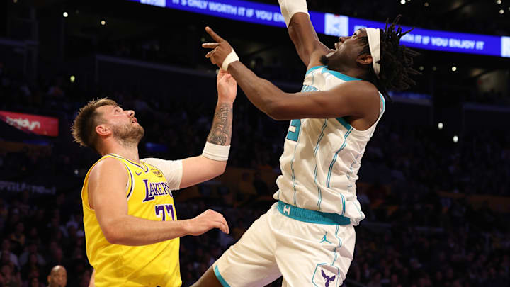 Feb 19, 2025; Los Angeles, California, USA; Charlotte Hornets center Mark Williams (5) shoots against Los Angeles Lakers guard Luka Doncic (77) during the third quarter at Crypto.com Arena. Mandatory Credit: Jason Parkhurst-Imagn Images