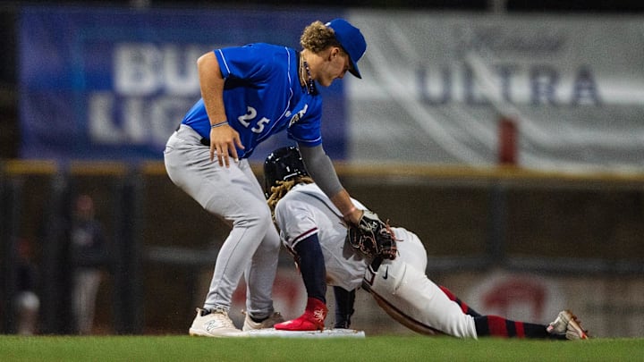 Biloxi Shuckers' Brock Wilken (25) attempts unsuccessfully to tag Mississippi Braves' Justin Dean (1) out during the game at Trustmark Park in Pearl, Miss., on the Brave's opening day, Tuesday, April 9, 2024. Braves won 2-0 after the game was called in the top of the eighth inning due to a tornado warning.
