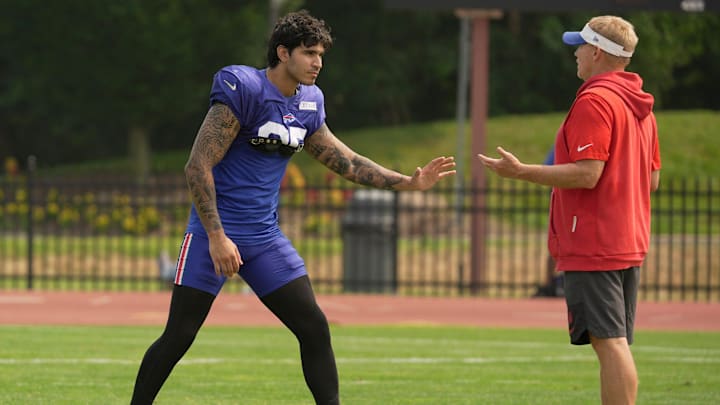 Buffalo Bills linebacker Jimmy Ciarlo stays after practice for advice from special teams coordinator Chris Tabor.